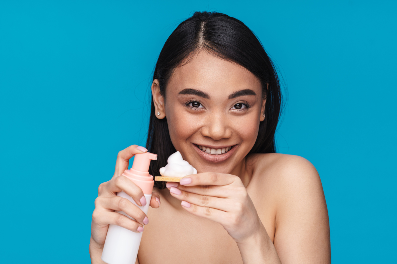 Optimistic Young Woman Holding Mousse Cleansing Foam.