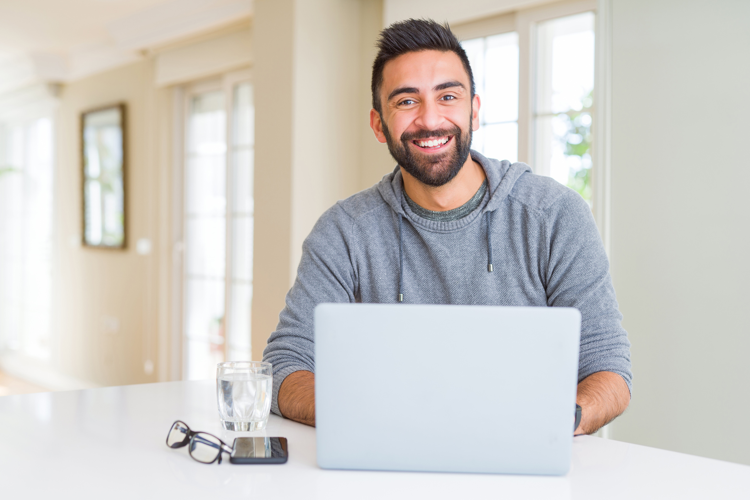 Man smiling working using computer laptop