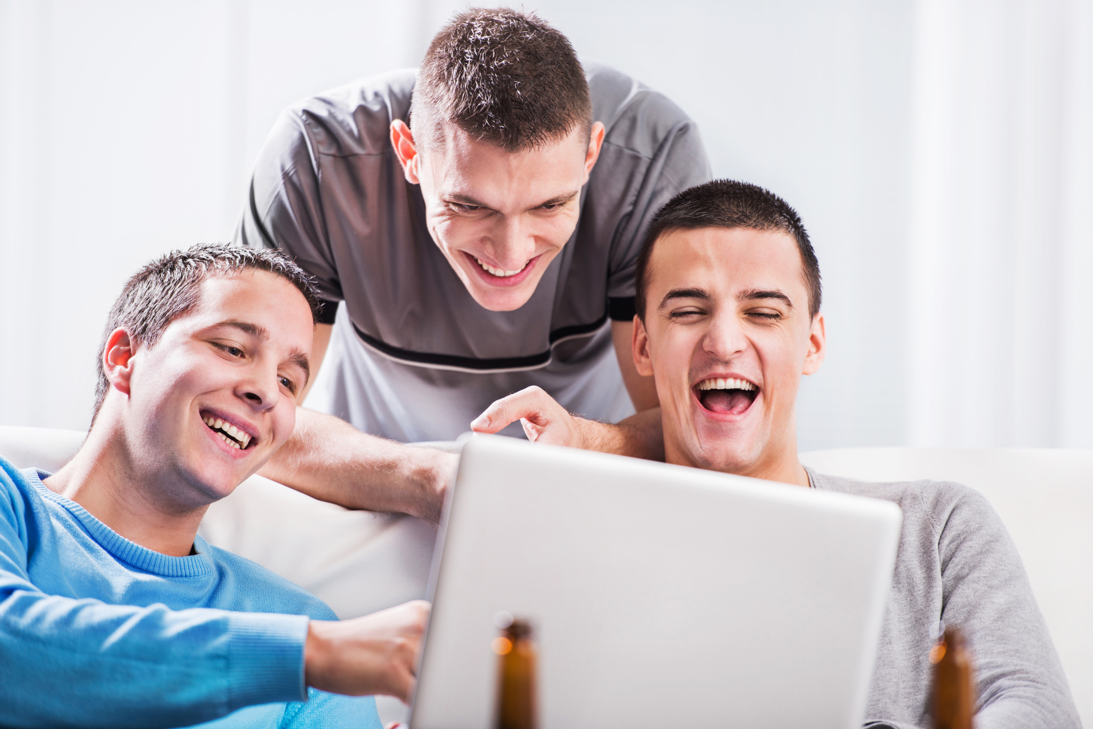 Young men using computer.